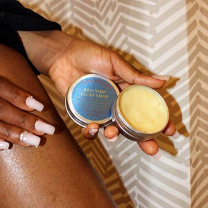 Chez Africa | Real Shea Relief Salve open tin, applied to leg